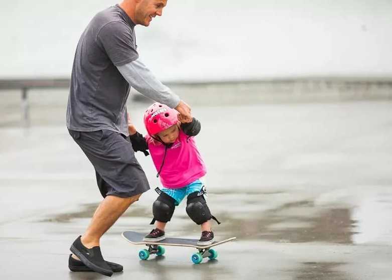 papa et bébé sur planche à roulettes